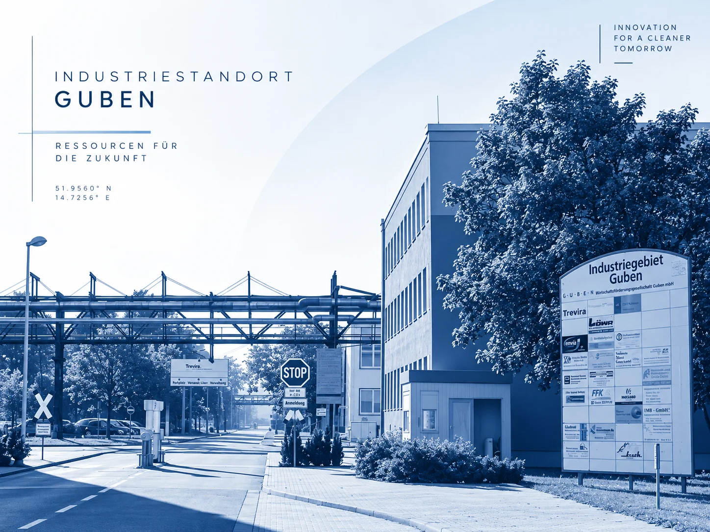 Entrance to the Guben industrial site with pipe bridge and company board